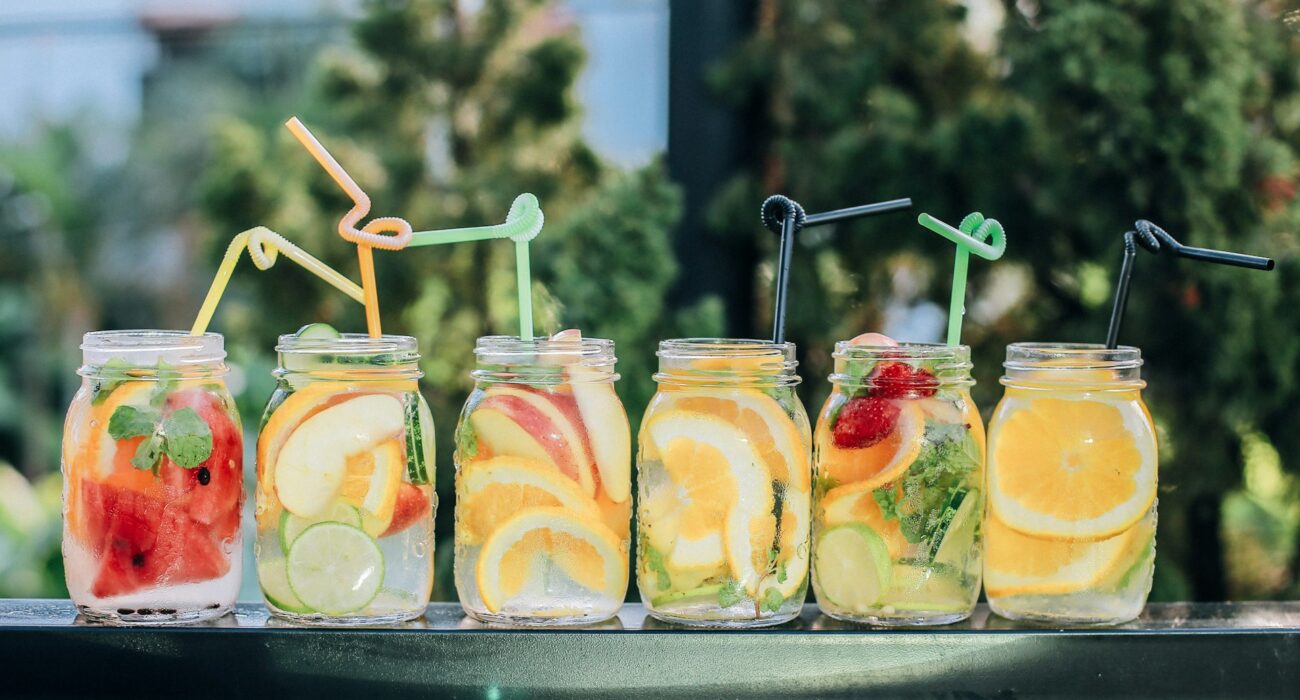 colorful glasses of fruit and juice outside on table