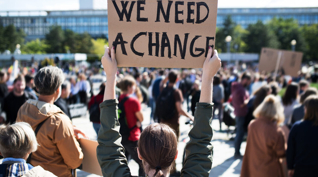 A rear view of people with placards and posters