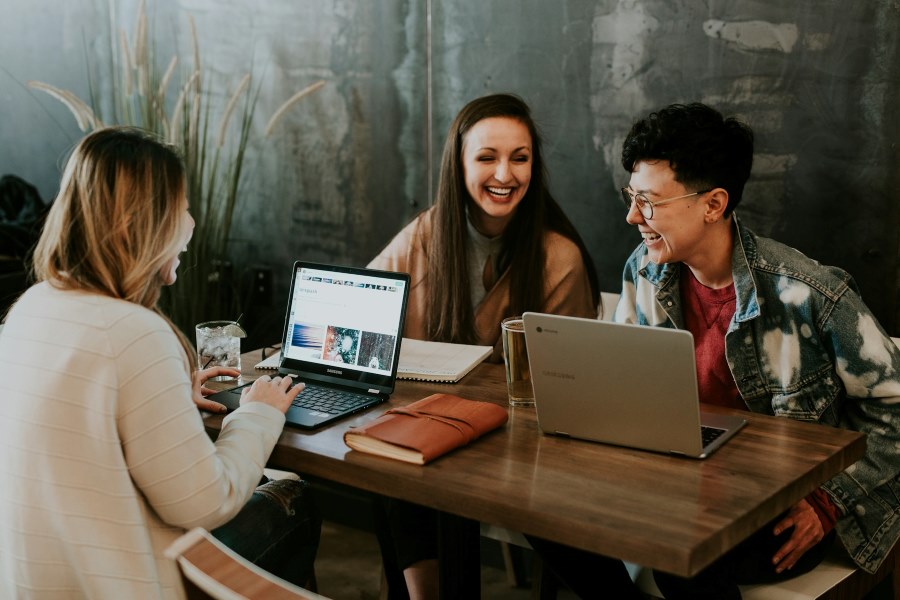 Young people at a table laughing