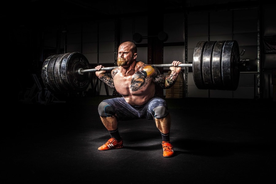 Bald man lifting weights